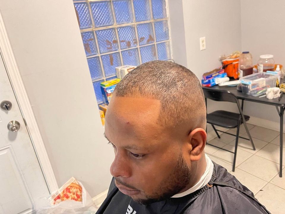 Close cut with a clean temple blend and a sharply lined beard
